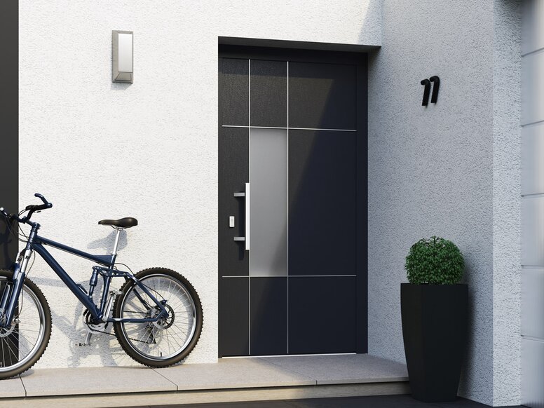 Front door with house number, bicycle, plant and lamp