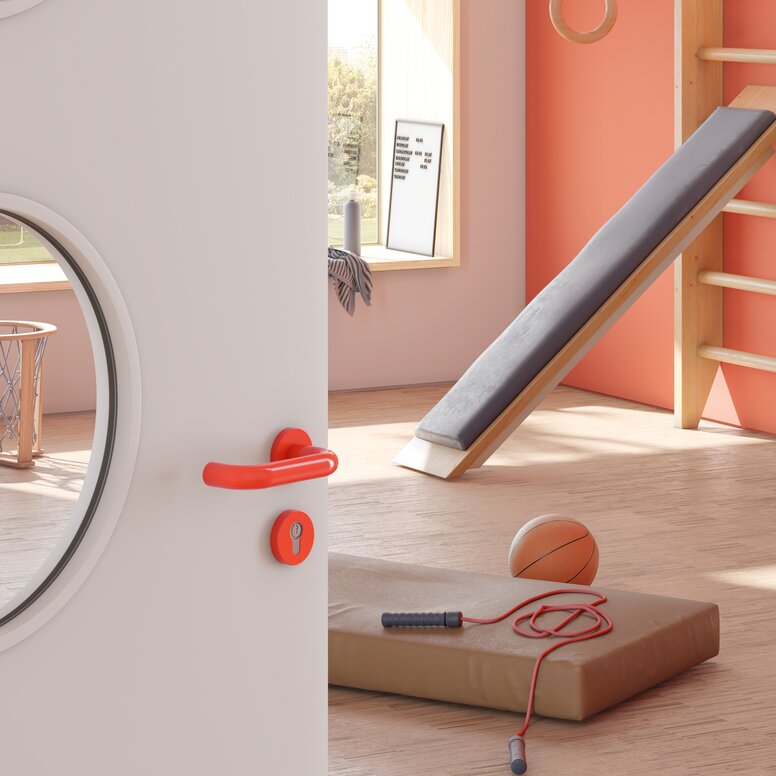 Door to a sports room of a kindergarten equipped with a lever handle in the colour orange made of polyamide