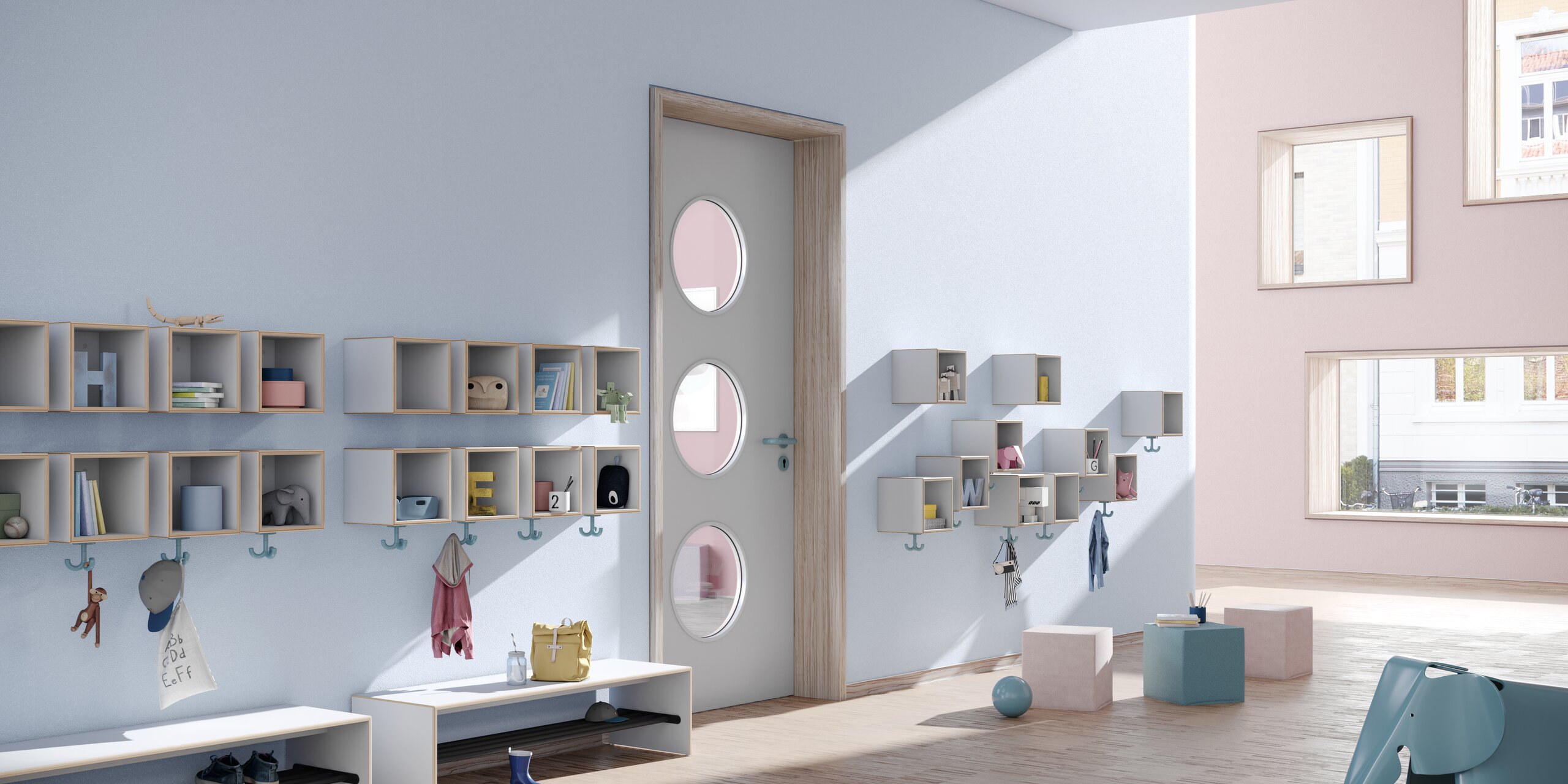 Blue kindergarten hallway with wall-mounted coat racks, triple hooks and seating