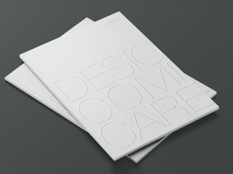 Twee gestapelde brochures met de naam Design Comfort Care