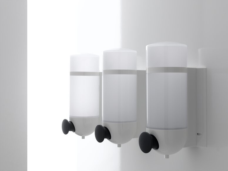 Trois distributeurs de savon HEWI au design cylindrique en polyamide blanc et bouton-poussoir en anthracite